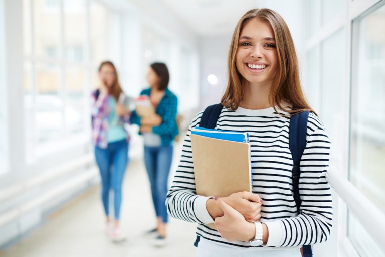 Portrait of beautiful smiing female college student